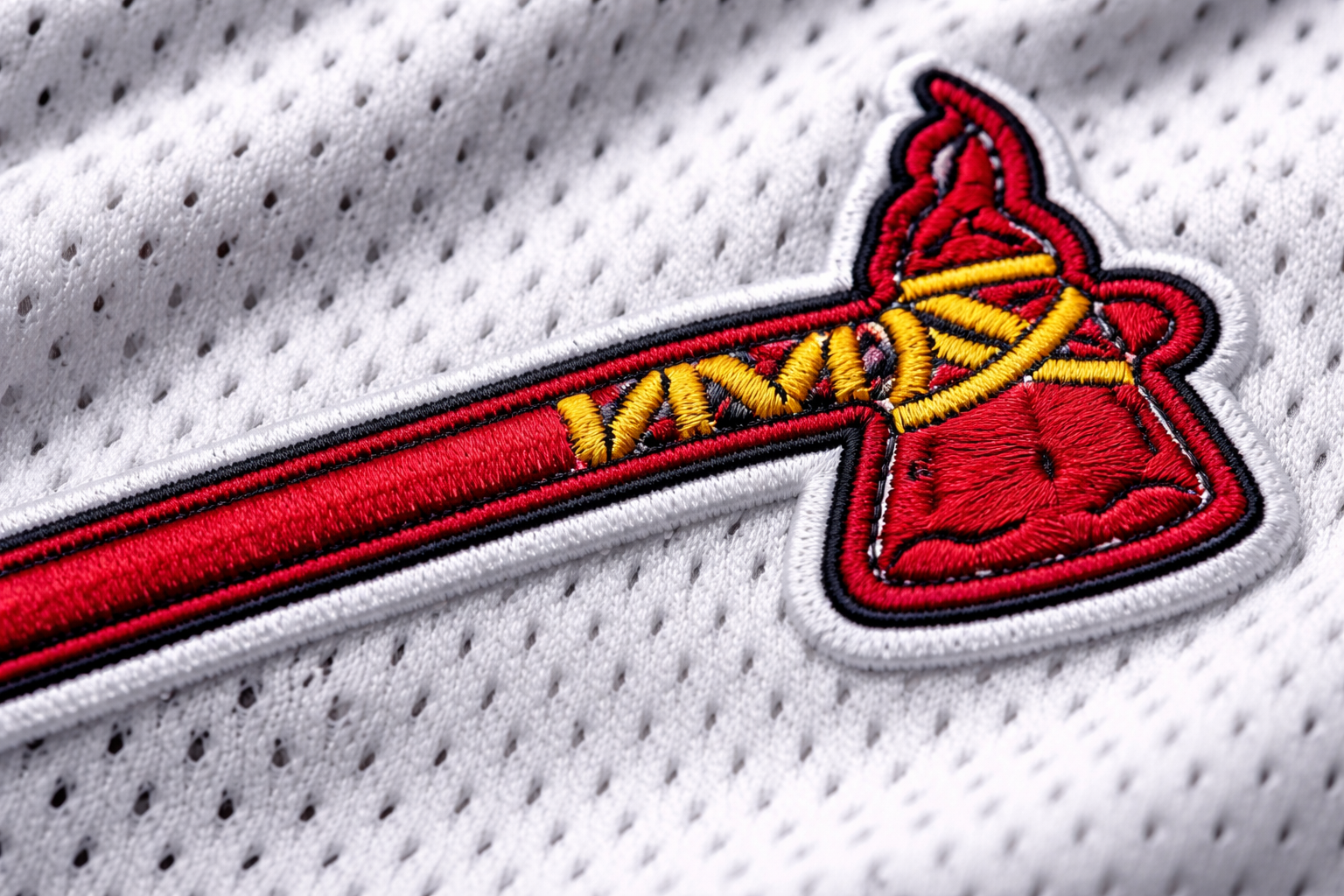 Macro close up of the red stitched tomahawk on a Braves jersey.