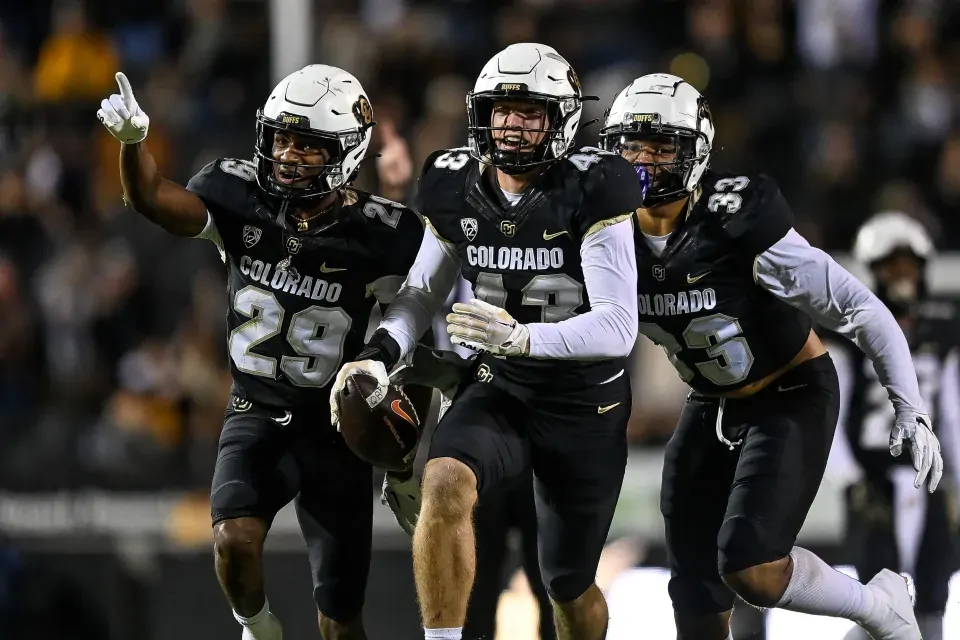 Close-up of gold embroidery on a stitched NCAA football jersey