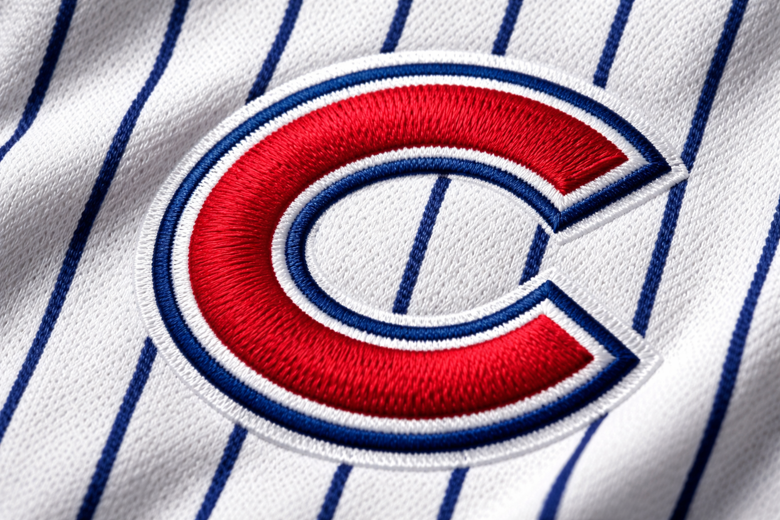 Chicago Cubs Jersey: Why Pinstripes Rule Wrigley Field 3 Macro close up of the blue pinstripes and stitched red 'C' logo on a Cubs jersey.