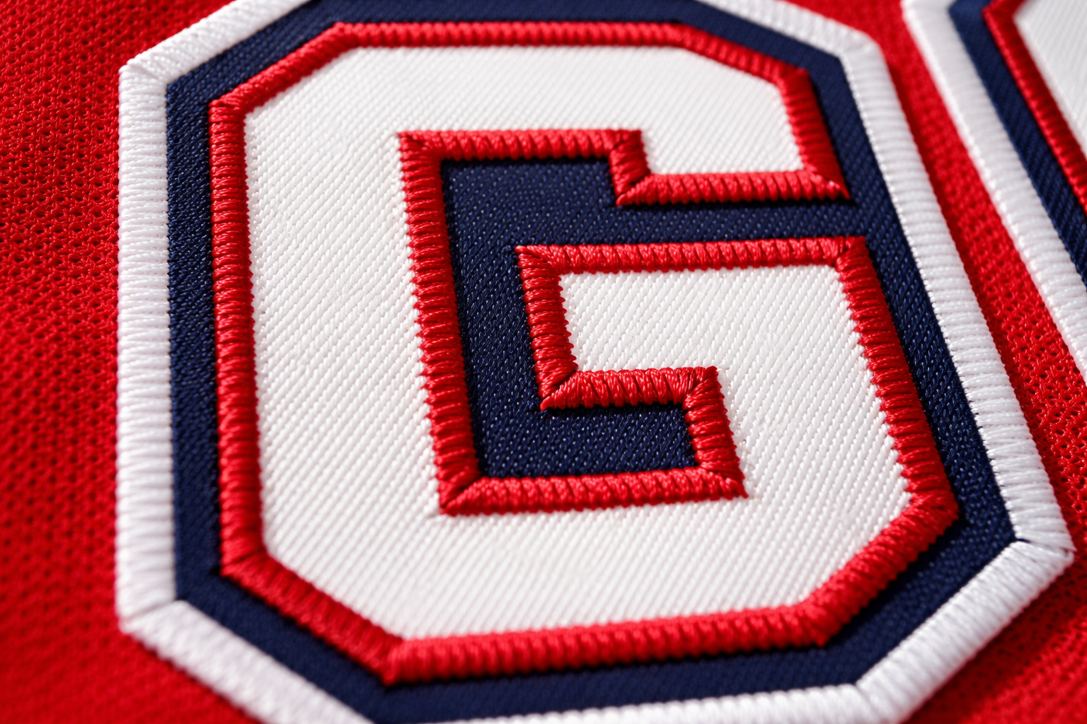  Macro close-up of the stitched letters on a Griswold hockey jersey.