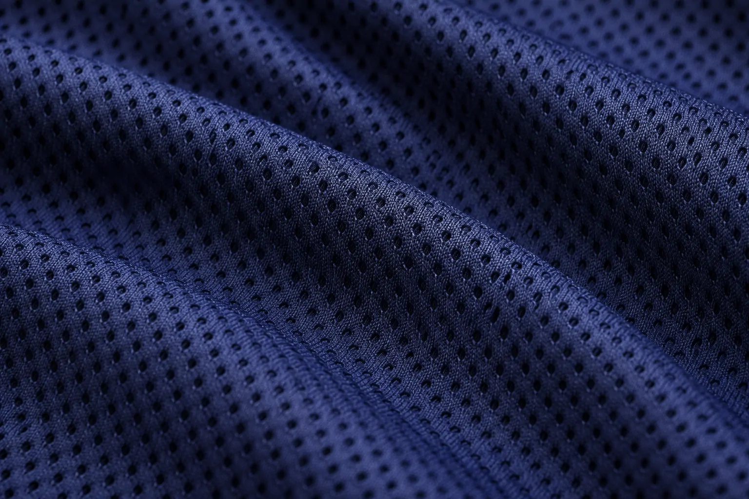 Close-up texture of high-quality polyester mesh fabric on a replica jersey
