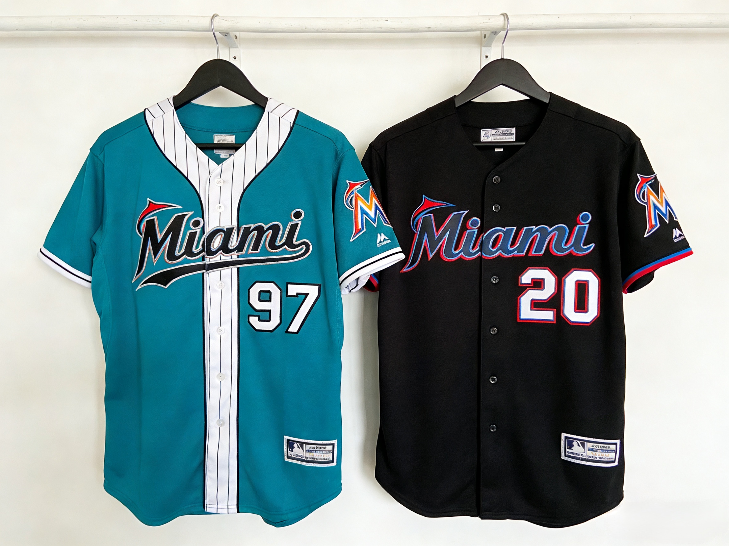 Side by side comparison of a classic teal Miami Marlins jersey and a modern black and red jersey.