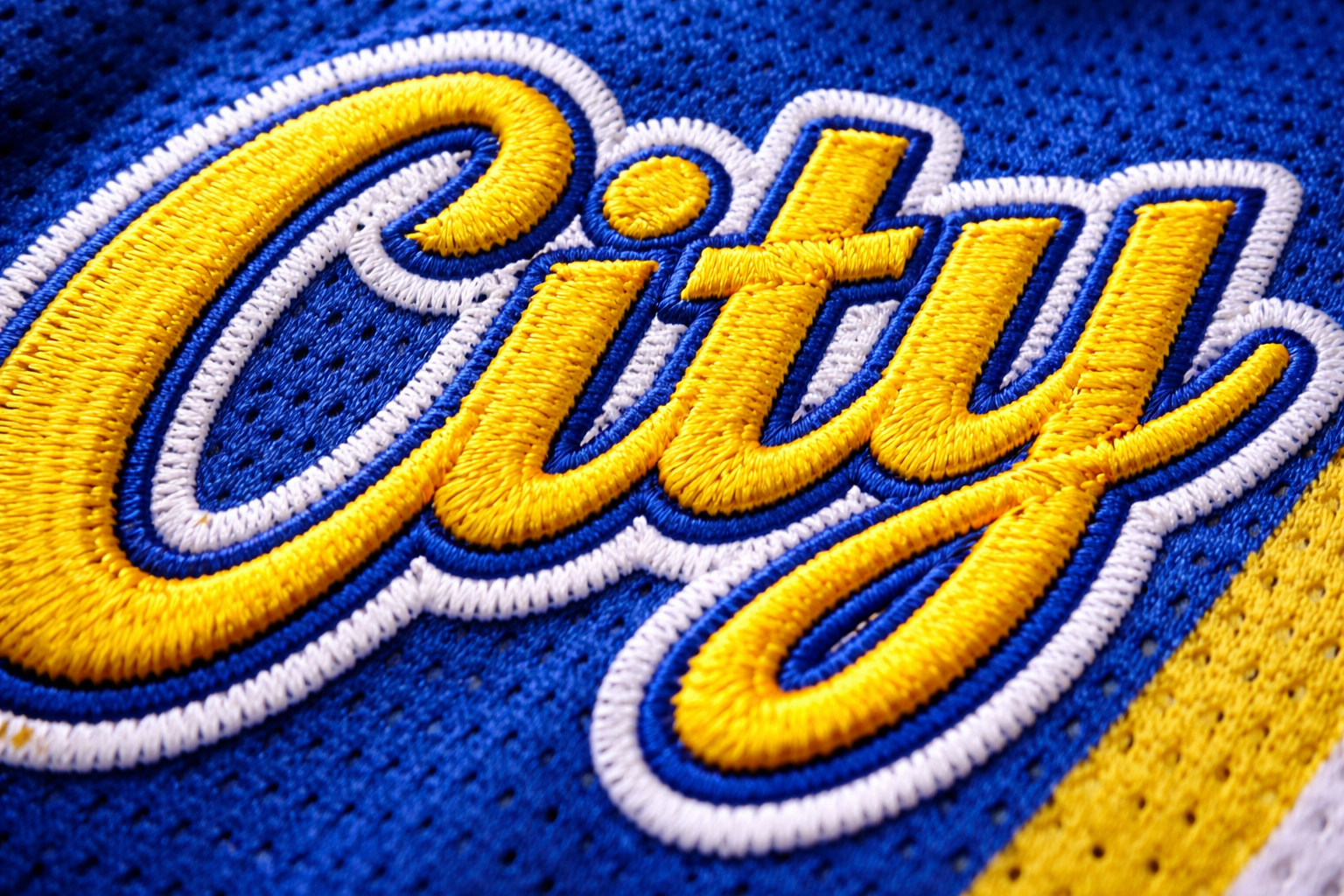 Macro close up of the stitched city script on a 2025 NBA City Edition jersey.