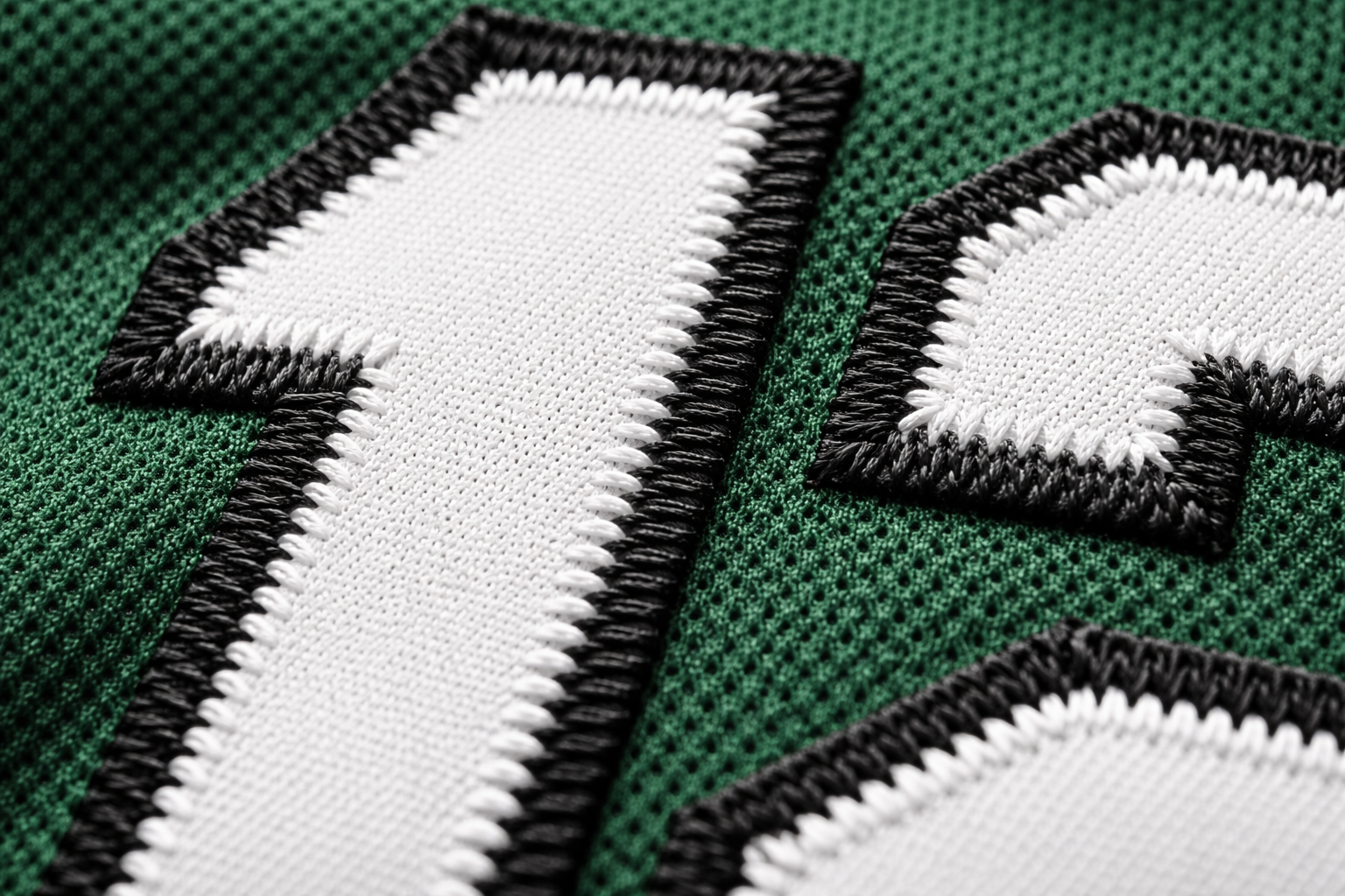 Macro close up of stitched tackle twill numbers on a New York Jets jersey.