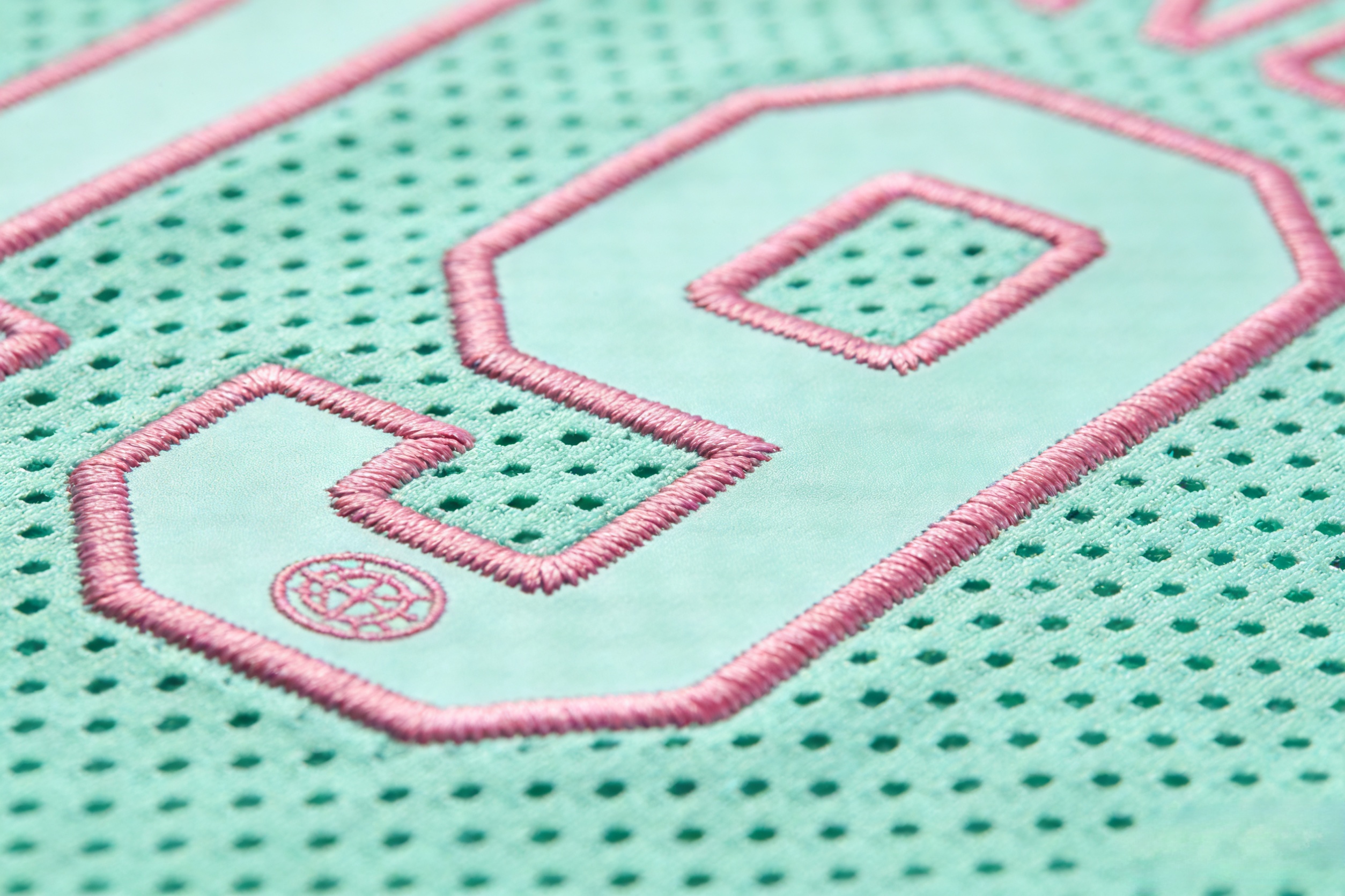 San Diego Padres Jersey: City Connect vs. Classic Brown Guide 3 Macro close up of the neon pink and mint green stitching on a Padres City Connect jersey