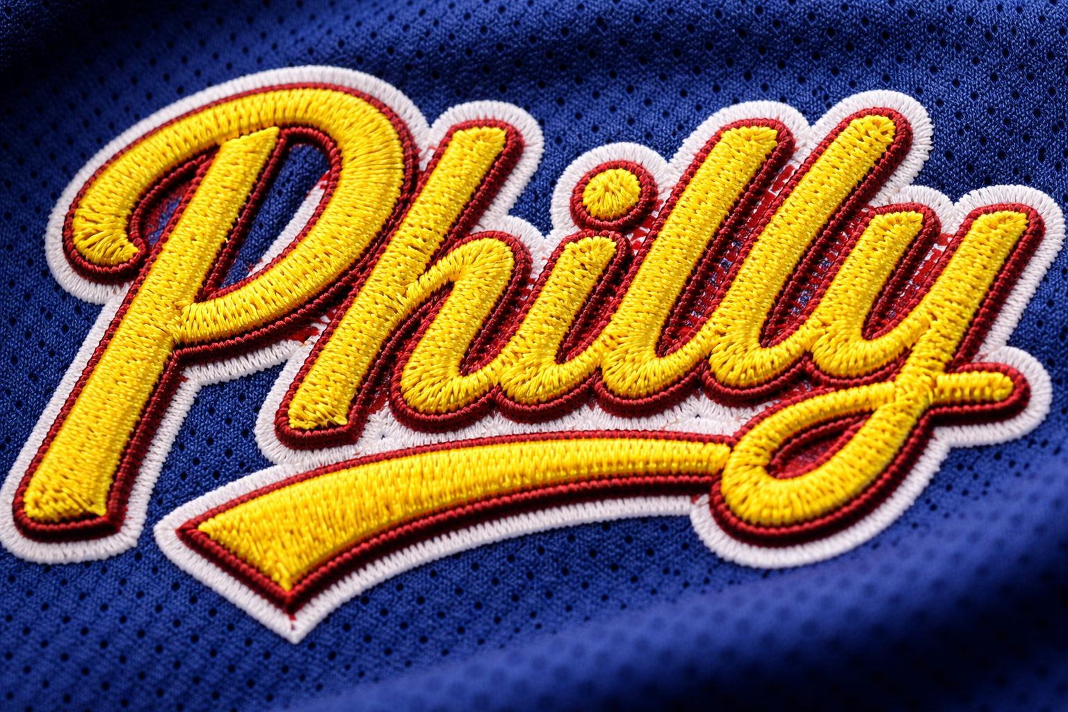 MLB City Connect Jerseys: Ranked Best to Worst (2026 Edition) 3 Close up of the stitched 'PHILLY' script on a blue and yellow jersey