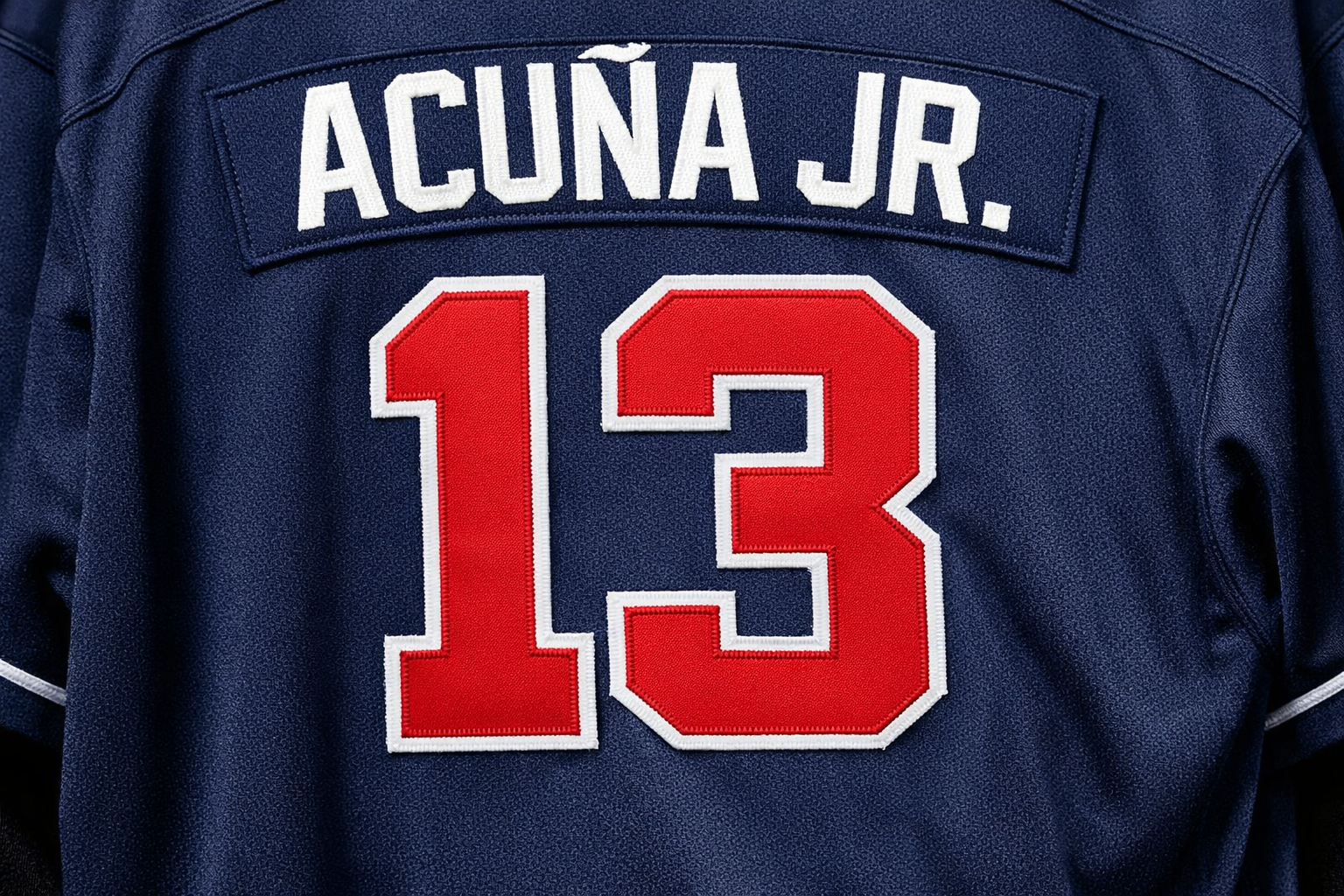 Back view of a Ronald Acuña Jr. #13 Atlanta Braves jersey with stitched nameplate