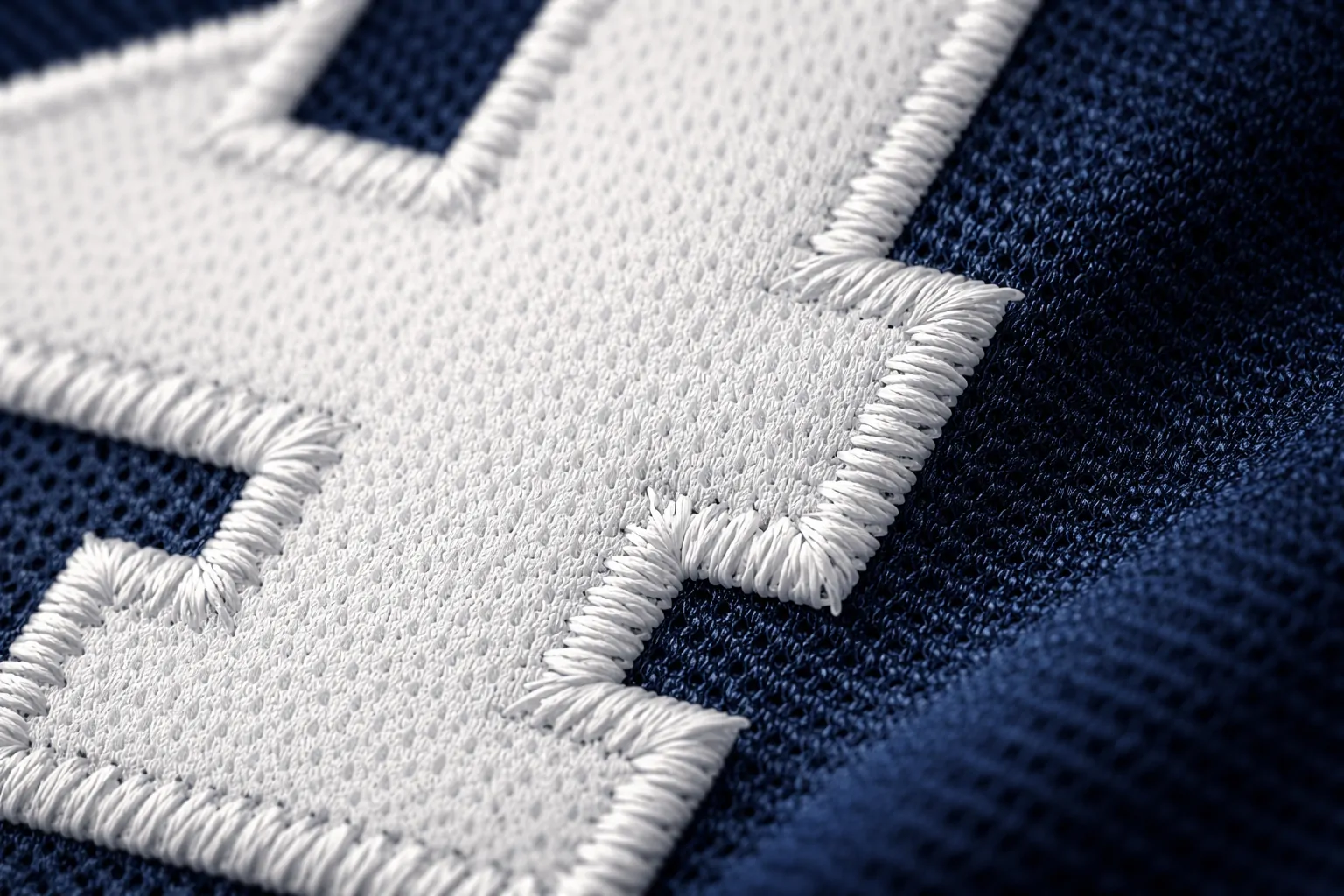 Close up macro shot of stitched tackle twill numbers on a Miami Dolphins jersey.