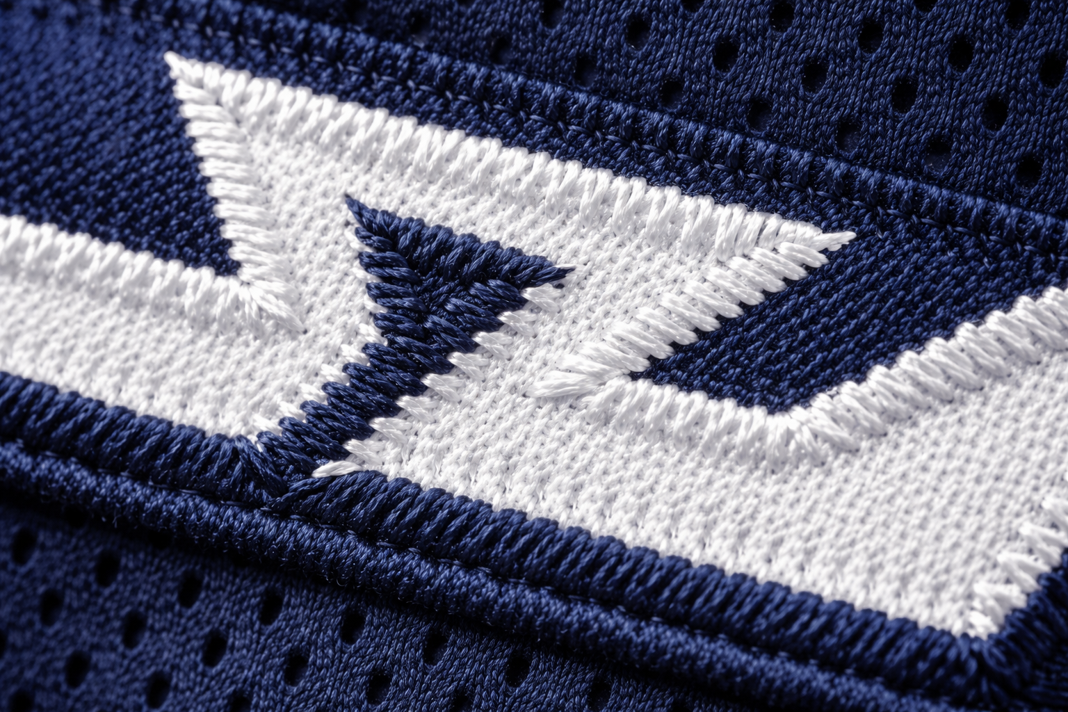 Macro close up of stitched tackle twill numbers on a youth football jersey.