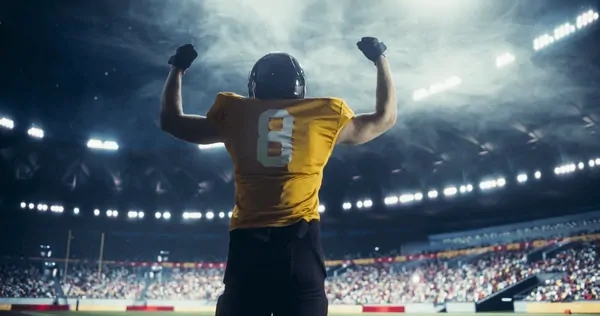 Action shot of a football player in a Colorado Buffaloes #12 jersey