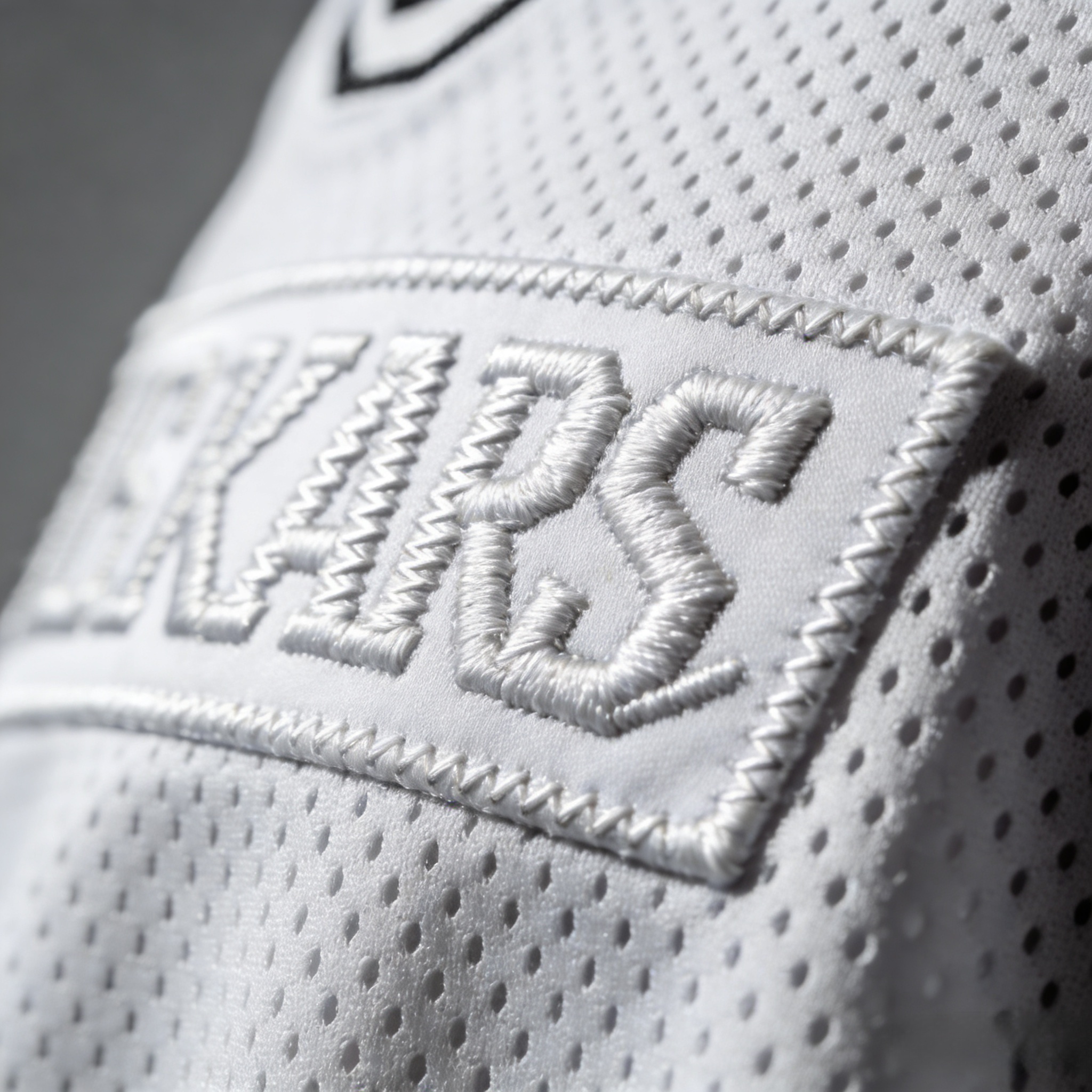 Top 5 90s Basketball Jerseys for Summer Festivals: 2026 Style Guide 3 Macro close up of stitched tackle twill letters on a custom basketball jersey.