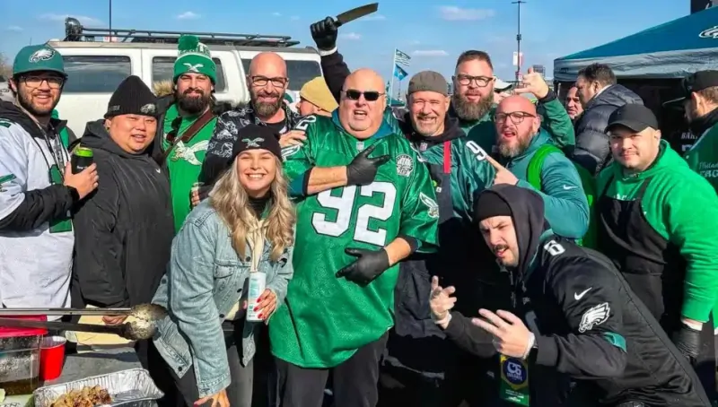Fans wearing Kelly Green Philadelphia Eagles gear at a tailgate
