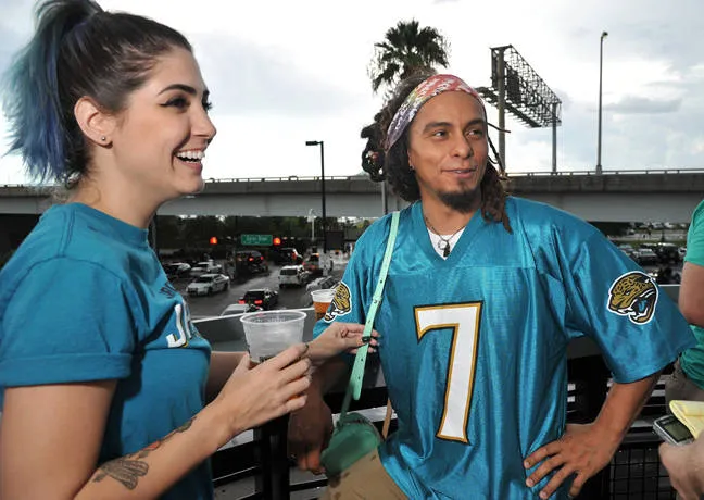 Custom Football Jersey: Design Your Personalized NFL Look 3 Fans enjoying a funny custom jersey at a football game