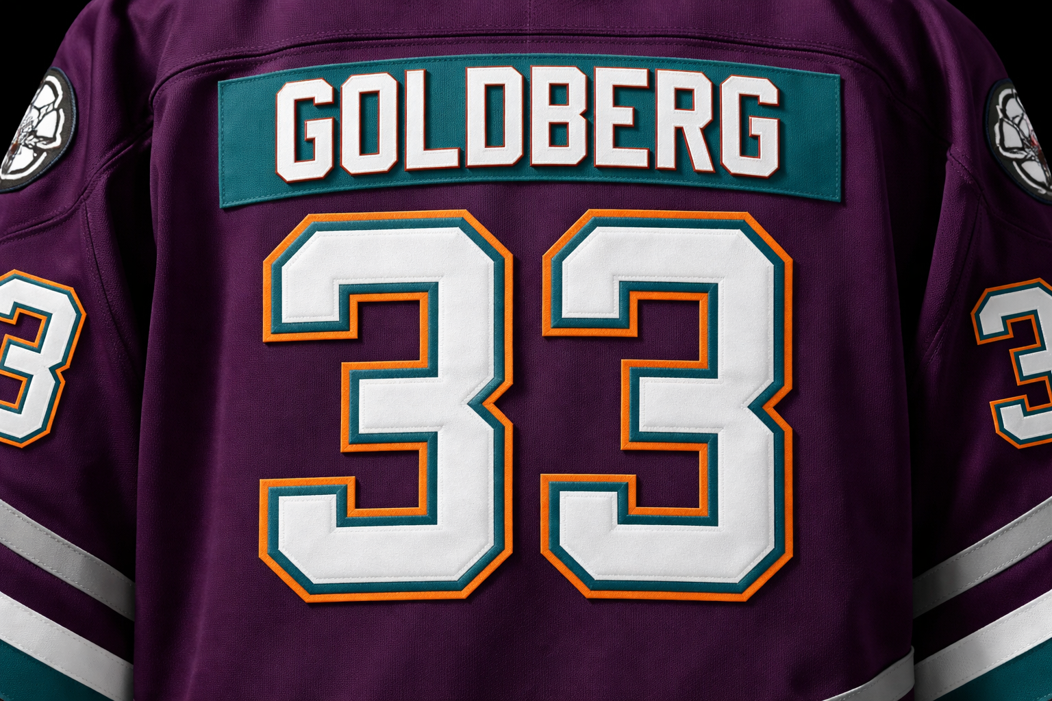 Back view of a Goldberg #33 Mighty Ducks jersey with stitched nameplate.