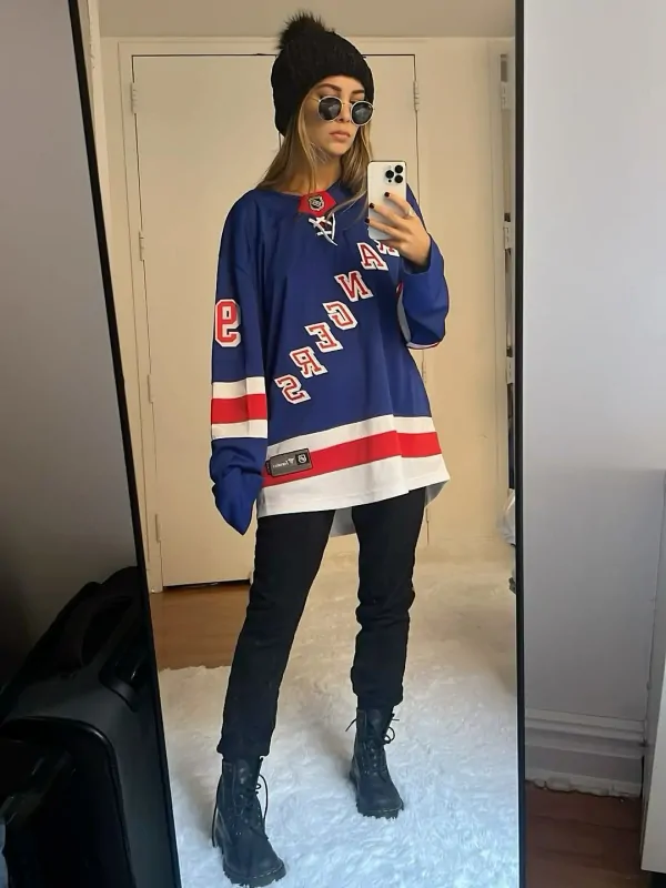 Fan wearing an oversized custom hockey jersey over a hoodie