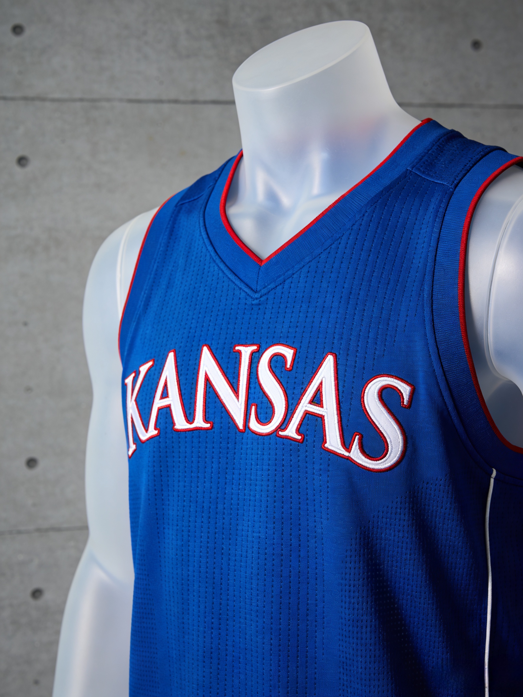 Royal blue Kansas Jayhawks basketball jersey with red and white stitched lettering.