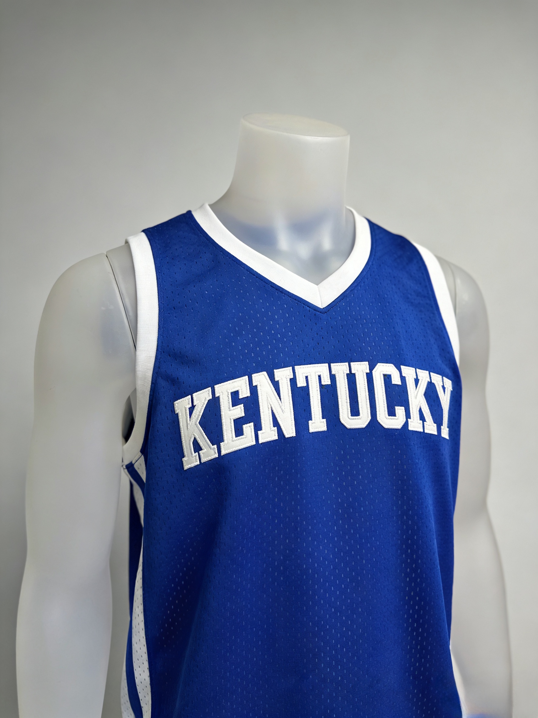 Royal blue Kentucky Wildcats basketball jersey with white stitched lettering front view.