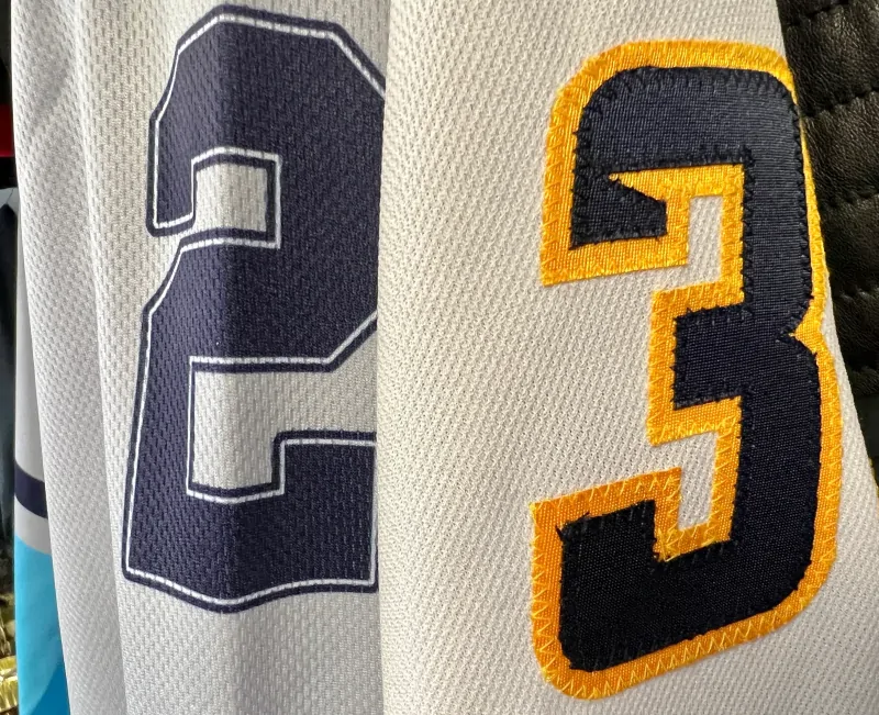 Comparison between stitched embroidery and flat printed jersey numbers