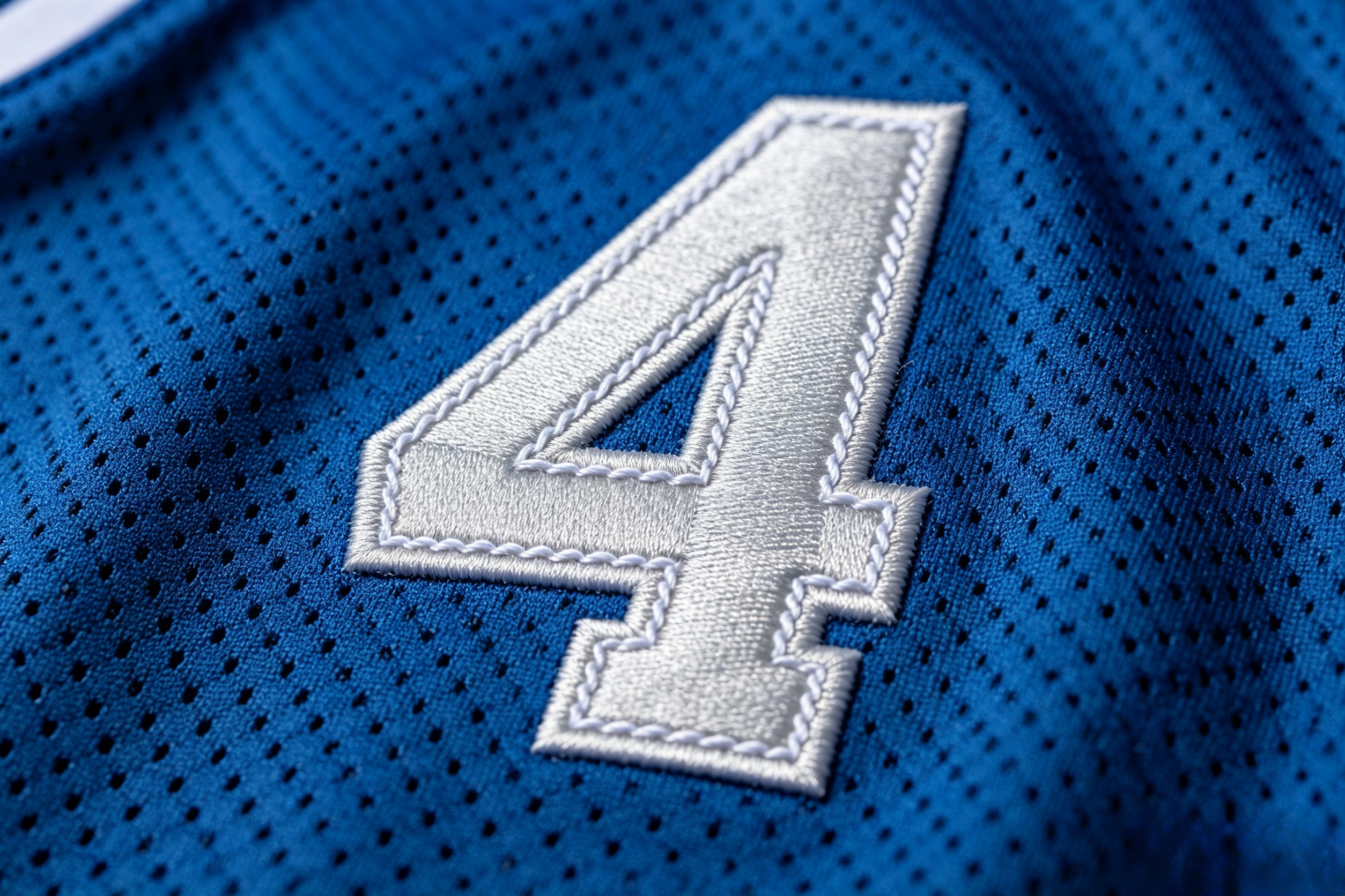 Close-up of premium silver stitching on a Detroit Lions jersey