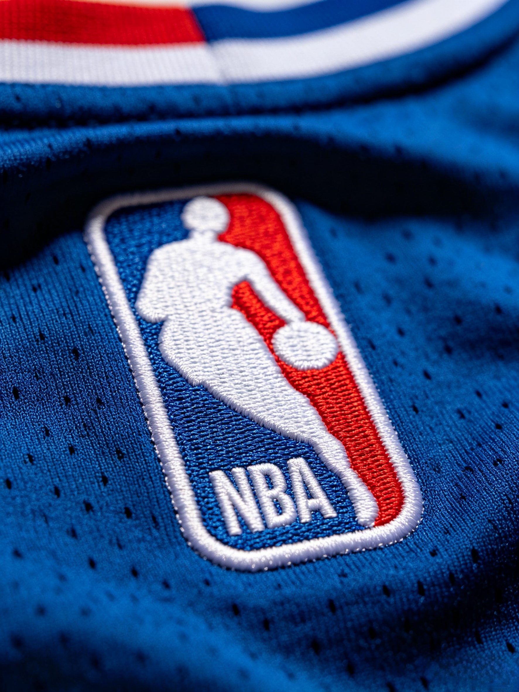 Detailed close-up of a premium stitched NBA logo on a jersey