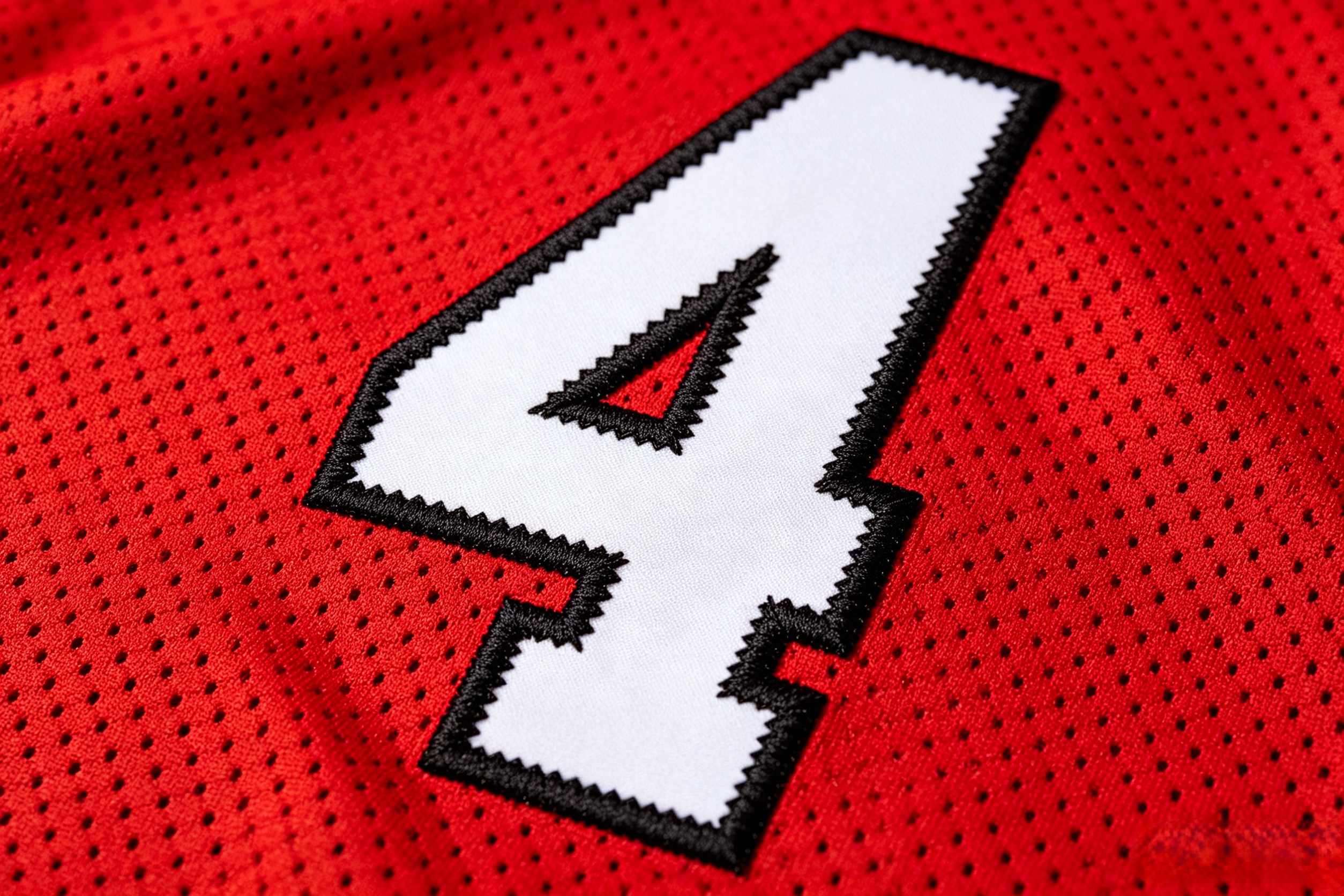 Close-up of premium tackle twill stitching on a Fred Warner jersey