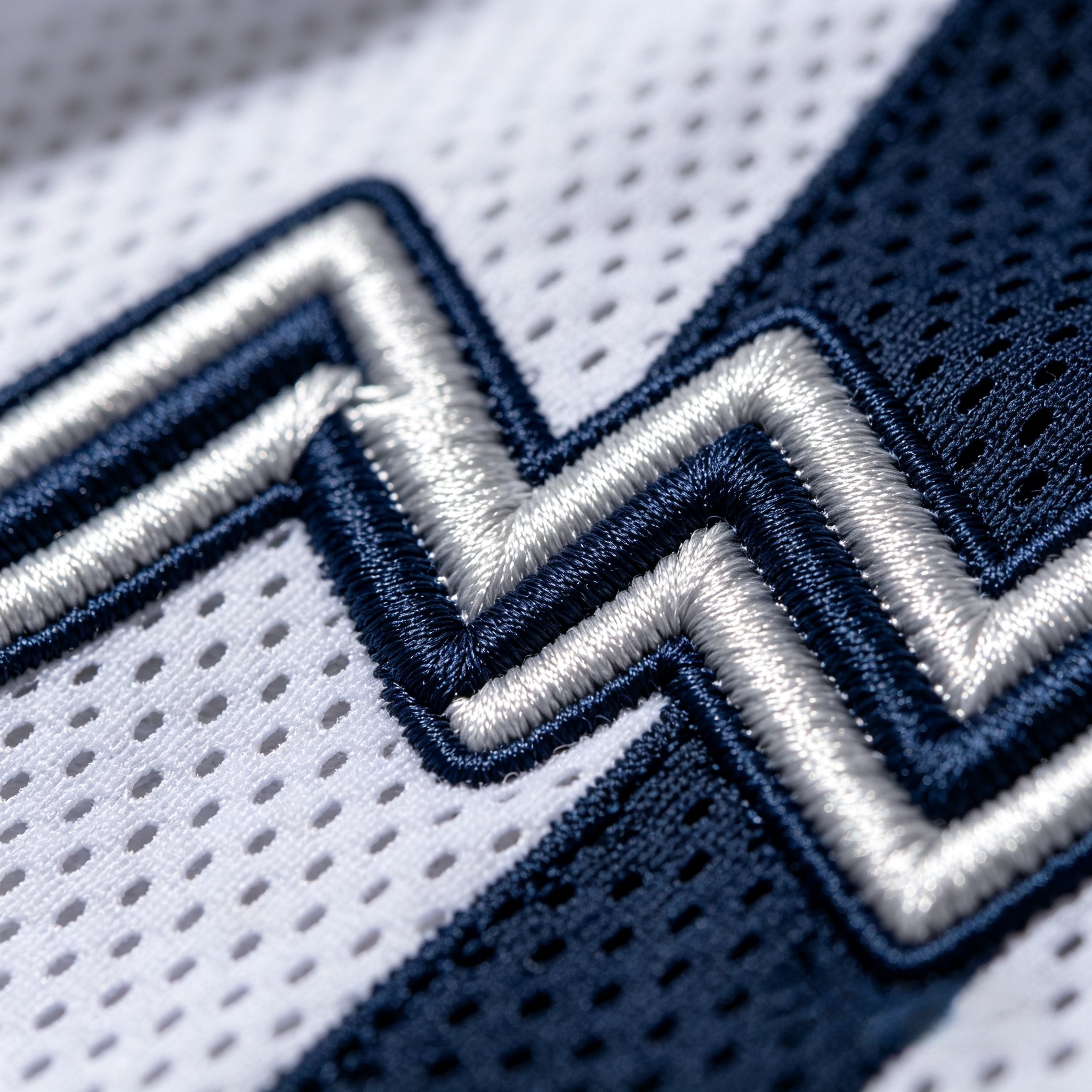 Detailed close-up of premium tackle twill stitching on an NFL jersey
