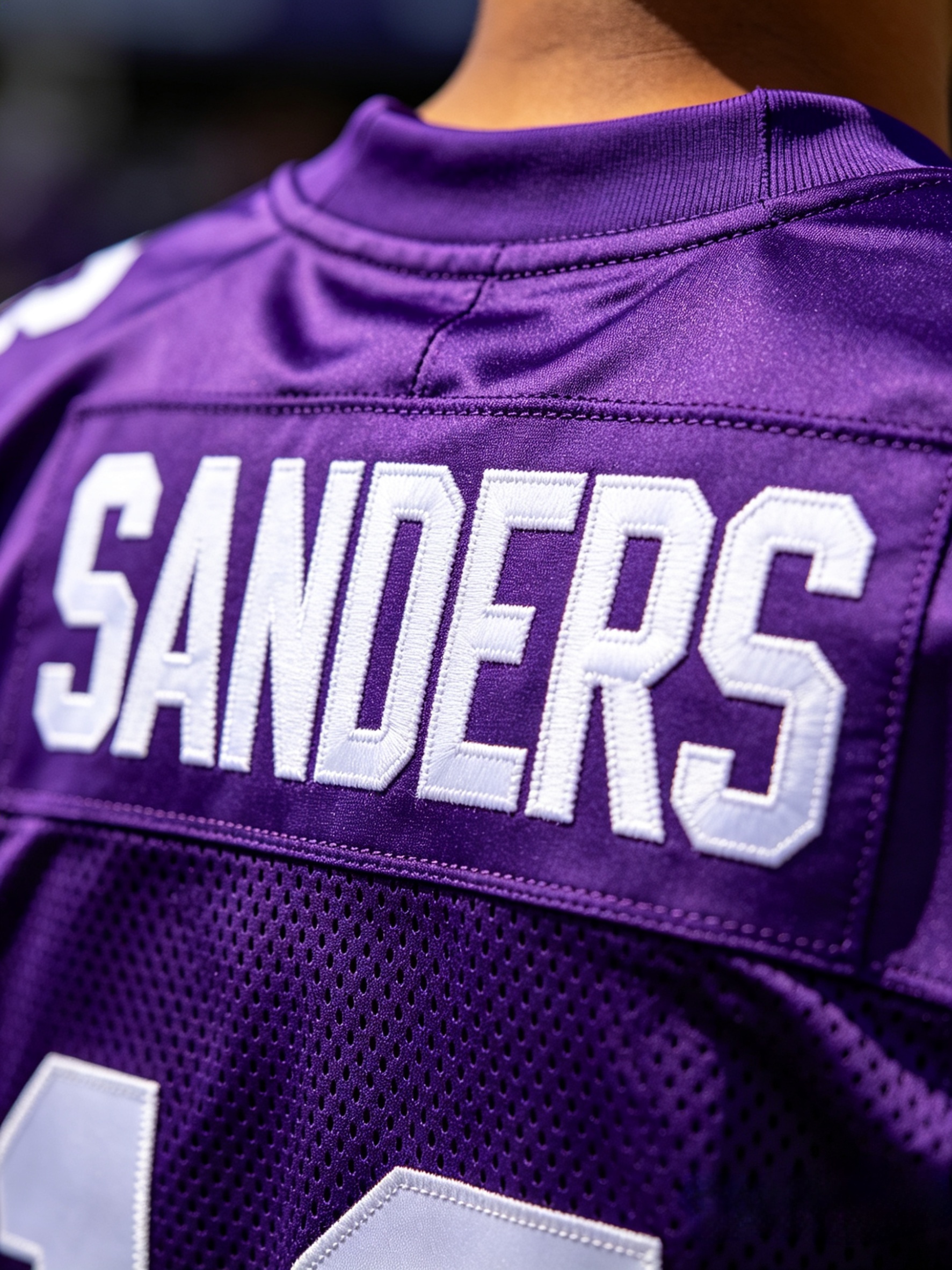 Close-up of premium tackle twill stitching on an NIL jersey nameplate