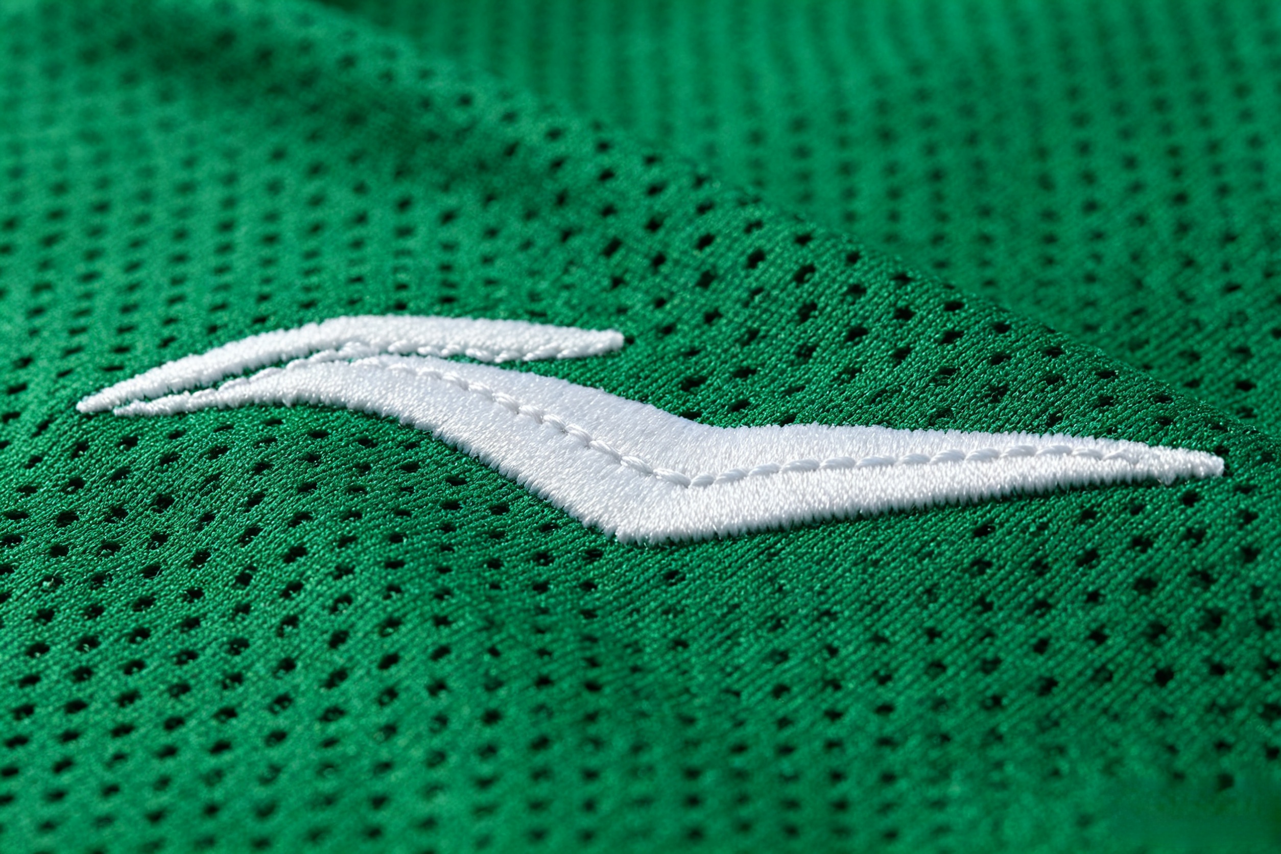Close-up of premium tackle twill stitching on a plus size jersey