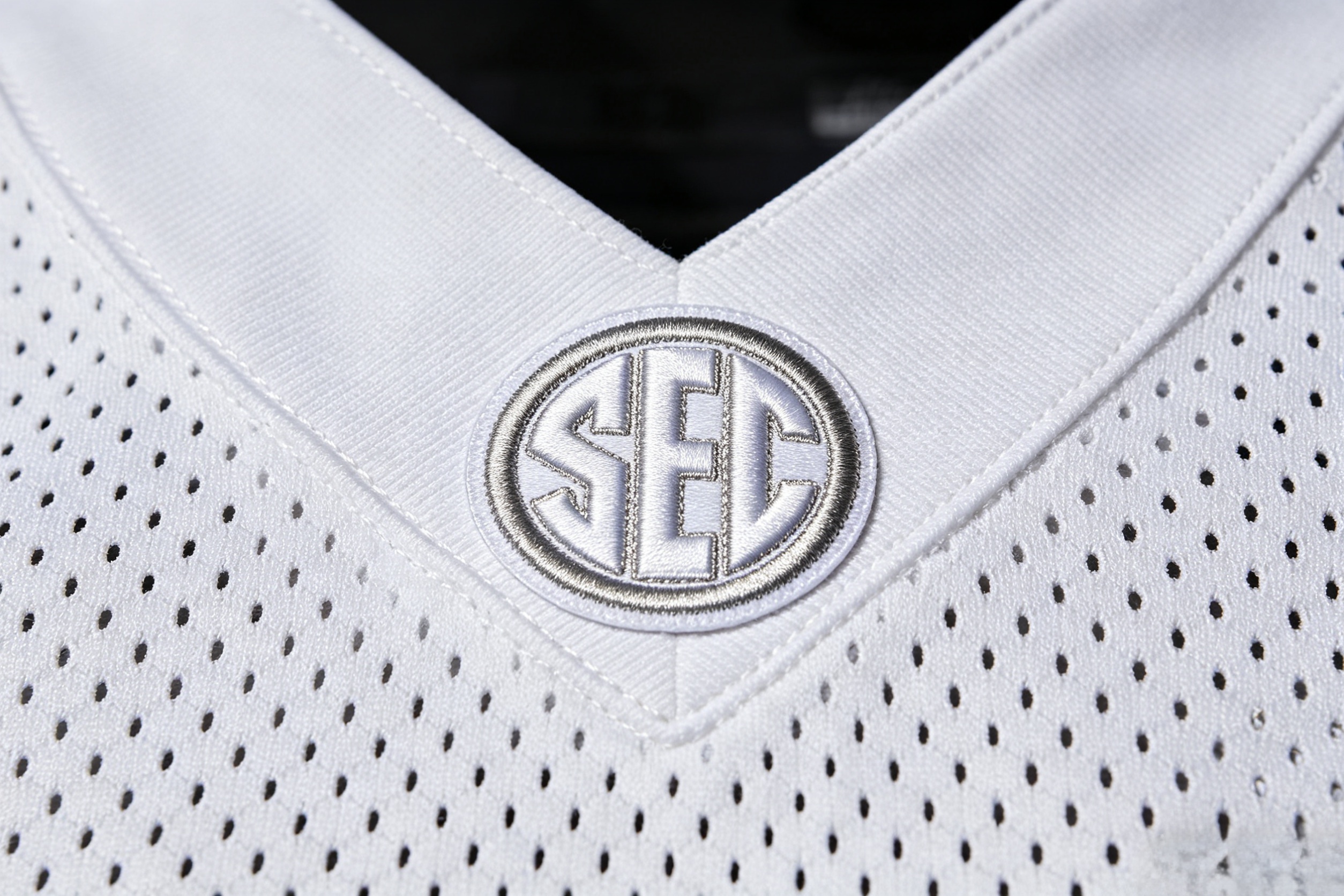 Detailed close-up of a stitched SEC logo patch on a jersey