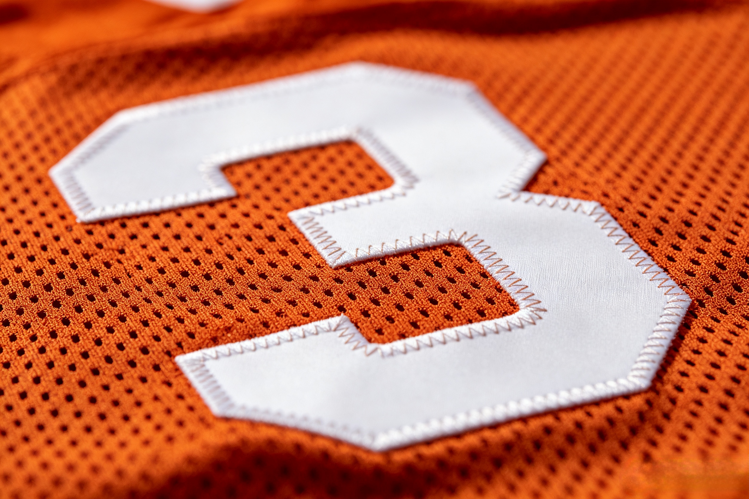 Close-up of premium zigzag stitching on a Texas Longhorns jersey